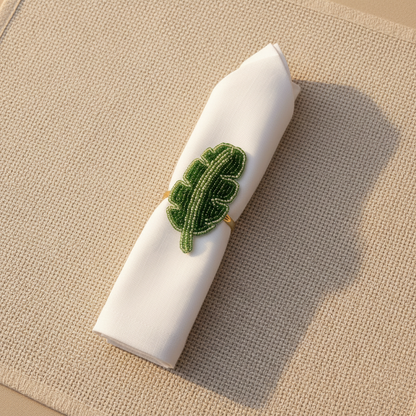 Banana leaf napkin ring with napkin on linen