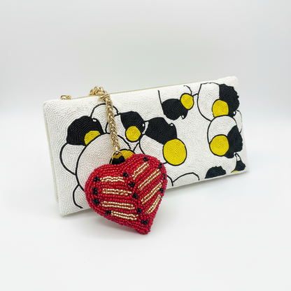 Coat of Arms charm on Potomitan clutch white background