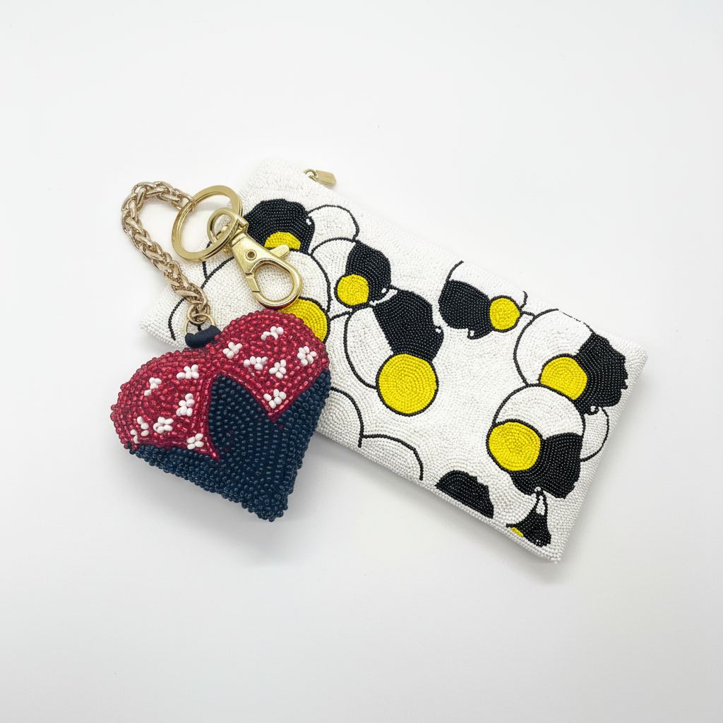 Ladybug charm styled with Potomitan clutch white background