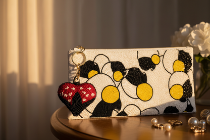 Ladybug heart charm on Potomitan clutch editorial